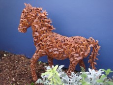 Metal horse composed of butterflies; side view