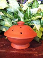 Terracotta mosquito coil holder.